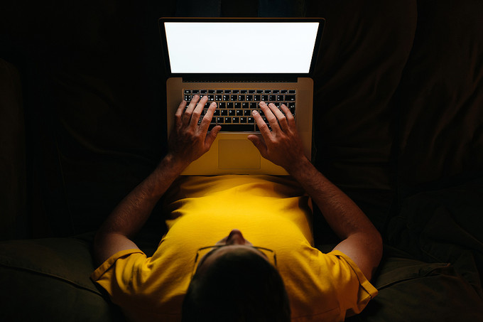Man Using Laptop in the Dark