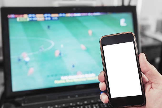 Mobile Phone In Front of Laptop Football