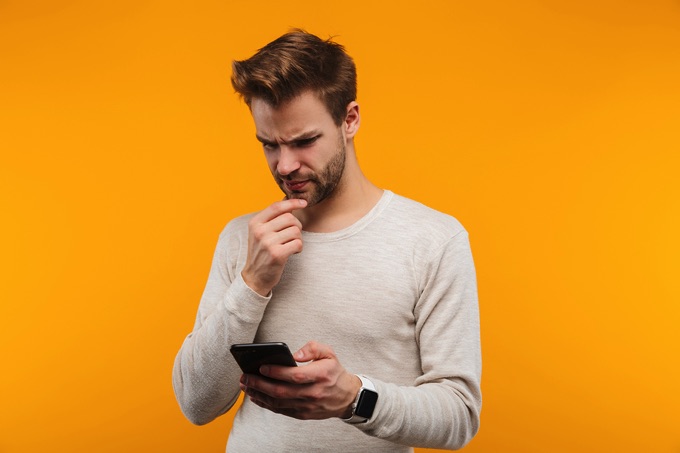 Confused man yellow background