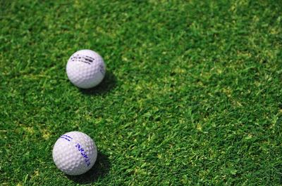 Two golf balls on the grass