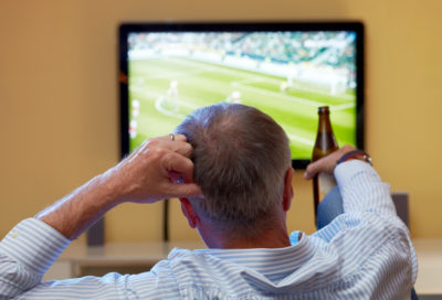 Man Watching Football on TV